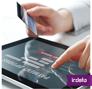 A woman uses a tablet device to pay for something with a credit card